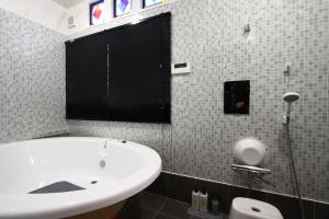 a bathroom with a white sink and a toilet at Bungee Inn in Minamiizu +25 photos