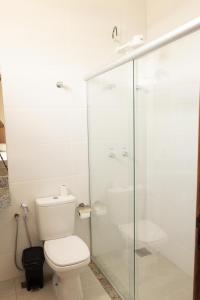 a bathroom with a toilet and a glass shower at Hotel Primavera Palace in Salinas