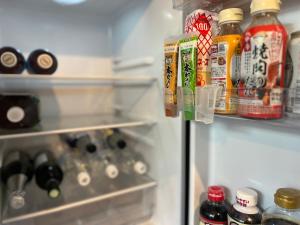 a refrigerator filled with lots of food and drinks at Bungee Inn in Minamiizu