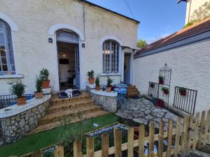 a dog is laying on the porch of a house at Candy house in Salies-de-Béarn