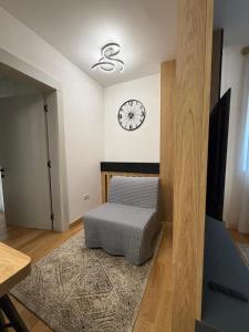 a room with a chair and a clock on the wall at City Garden II in Kolašin +8 photos