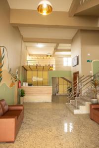 a lobby with a couch and stairs in a building at Hotel Primavera Palace in Salinas