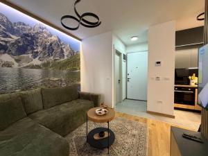 a living room with a couch and a table at City Garden II in Kolašin