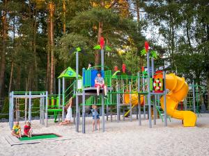 a playground with children playing on a slide at Camping Morski 21 in Łeba