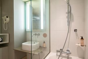 a bathroom with a shower and a sink at Nice Centre Hotel in Nice