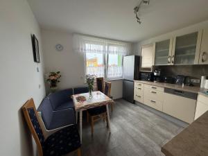 a kitchen with a table and a dining room at Apartment 4 rooms 'Bauer' in Korfantów