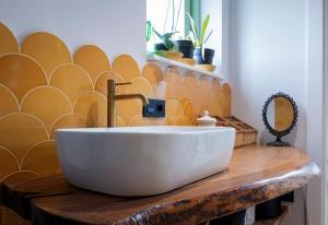 a bathroom with a white sink on a wooden table at El Sueño, La Perla in Barres +11 photos