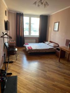 a bedroom with a bed and a desk and a window at Міні готель вулиця Чавдар in Kyiv