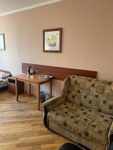 a living room with a couch and a table at Міні готель вулиця Чавдар in Kyiv