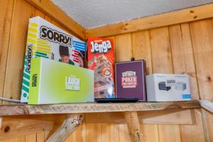 a shelf with two laptops and boxes on it at Timber Ridge Cabin: Rustic Getaway in Rapid City