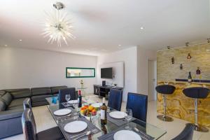 a living room with a table and a couch at Villa Sunshine Lanzarote by Villa Plus in Teguise
