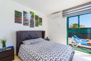 a bedroom with a bed and a window at Villa Sunshine Lanzarote by Villa Plus in Teguise