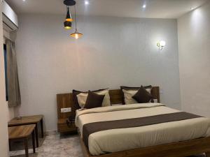 a bedroom with a large bed in a room at Serenity By The Ganges in Haridwār +31 photos