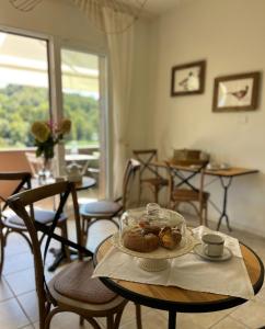 a table with a plate of pastries on it at da Tony home B&B in Tarzo