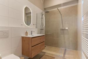 a bathroom with a sink and a shower at Boerderij appartement 't Vogelnest in Heiloo +29 photos