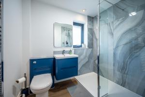 a bathroom with a toilet and a sink and a shower at Annabella Cottages in Crossford +47 photos