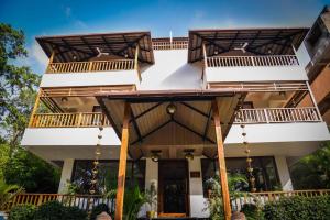 a building with balconies on top of it at Anantya At Anamiva in North goa