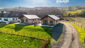 an aerial view of a house on a dirt road at Annabella Cottages in Crossford