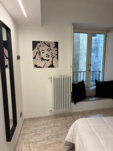 a white room with a bed and a window at Suite romantica a Como Centro in Como