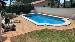 a swimming pool on a tiled patio with at Villa Las Palmas in Benicàssim