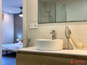 a bathroom with a sink and a mirror on a counter at Villa Las Palmas in Benicàssim +55 photos