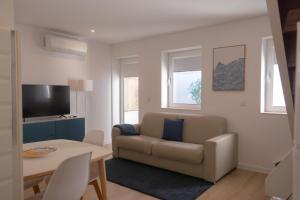 a living room with a couch and a table at OportoWaves in Matosinhos
