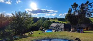 a house on a hill with a pool in the yard at Apartmány Javorek in Sněžné