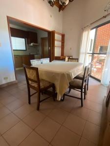 a dining room with a white table and chairs at Casa a metros de todo in Federación +5 photos