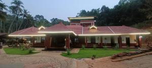 a house with lights on top of it at Srikadhama in Udupi