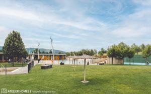 a park with a playground and an umbrella in the grass at Terraza Varellas in Latas