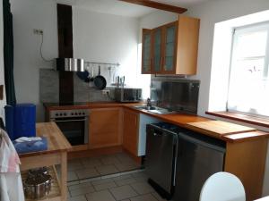 a kitchen with wooden cabinets and a stove top oven at Fewo Haus Patze in Betzendorf