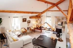 a living room with a white couch and a table at Résidence Espéraza ADULTS ONLY in Espéraza