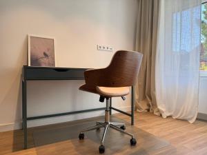 a chair sitting in front of a desk at Superior Apartment mit 1 Schlafzimmer in Hildesheim