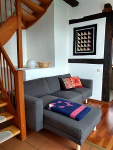 a living room with a couch and a staircase at Fewo Haus Patze in Betzendorf