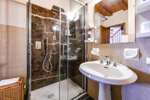 a bathroom with a sink and a shower at Luxury Castle View in Sirmione +30 photos