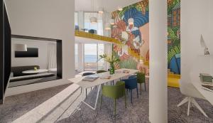 a dining room with a table and chairs with a mural at nhow Marseille in Marseille