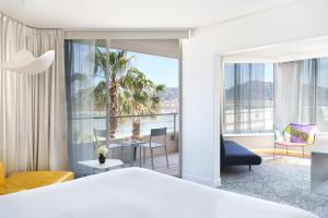 a hotel room with a view of a bedroom at nhow Marseille in Marseille