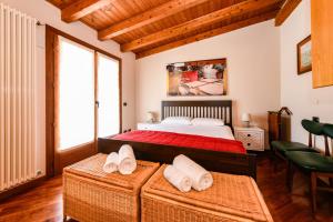 a bedroom with a bed and two chairs in it at Luxury Castle View in Sirmione