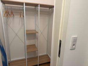 a walk in closet with a glass door at Superior Apartment mit 1 Schlafzimmer in Hildesheim