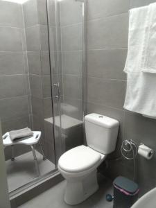 a bathroom with a toilet and a shower at Angel House in Ermoupoli +1 photo