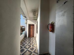 a hallway with a fire extinguisher on the wall at SRT Homes Ranchi in Rānchī