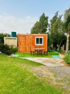 a tiny house with a picnic table in a yard at Bungalow with Pool View & Breakfast in Marrakesh