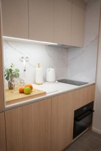 a kitchen counter with a cutting board with fruit on it at Rezidence Jakubská in Brno +20 photos