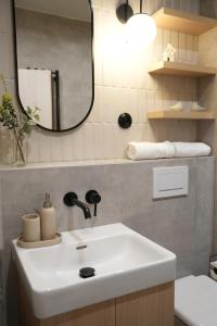 a bathroom with a white sink and a mirror at Rezidence Jakubská in Brno