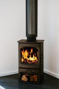 a stove with a microphone on top of it at The Hideaway on McFarlane, Mudgee in Mudgee