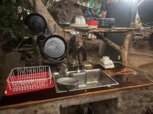 a kitchen with a sink and pots and pans at Patziapa in Santiago Atitlán