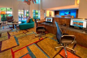 a lobby with a desk with a laptop and chairs at Fairfield Inn & Suites by Marriott Destin in Destin