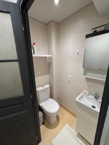 a bathroom with a toilet and a sink at Sur Tulle - Le Refuge - 1 Piece in Tulle
