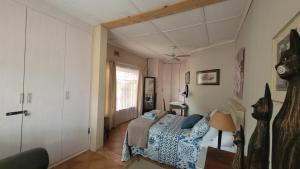 a bedroom with a bed and a window and a door at AtHome Apartments in Mokopane