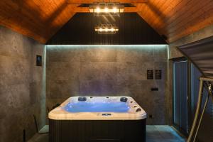 a large bath tub in a room with a ceiling at LakeHome&Spa nad Jeziorem Czorsztyńskim in Kluszkowce +44 photos